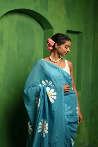 Huts and looms blue handloom cotton saree, featuring exquisite hand-painted floral designs throughout the saree.