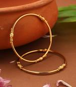 Gold plain bangles with center round ball accents