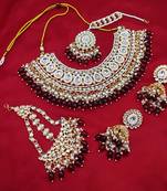 Luxurious maroon color kundan bridal necklace set with maang tikka and earrings