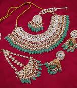 Luxurious mint color kundan bridal necklace set with maang tikka and earrings