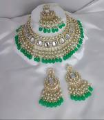 Luxurious kundan choker set with pearl and green bead accents - traditional indian bridal jewelry
