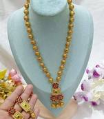 Elegant gold beaded necklace set with ruby and emerald pendant