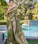 Exquisite designs with this mehandi green simar silk zari woven saree