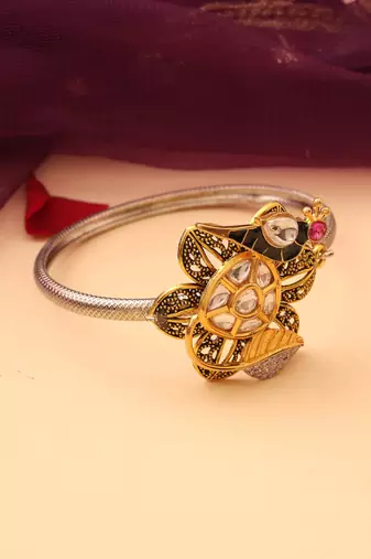 Silver peacock bracelet with floral accents