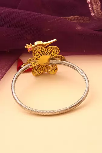 Silver peacock bracelet with floral accents