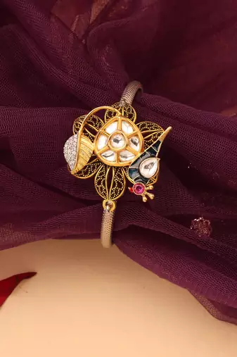 Silver peacock bracelet with floral accents
