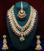 Opulent kundan bridal jewelry set with double-layer necklace, maang tikka, and jhumka earrings