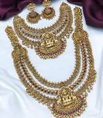 Grand temple design gold bridal necklace set with lakshmi motif and multi-color stones