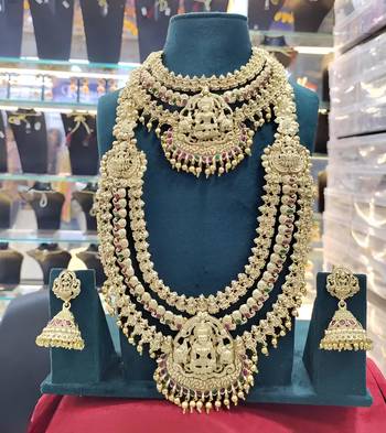 Grand temple design gold bridal necklace set with lakshmi motif and multi-color stones 2