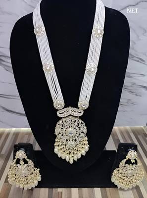 Elegant multi-layered pearl necklace set with intricate silver pendant and earrings 1