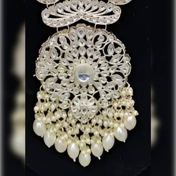 Elegant multi-layered pearl necklace set with intricate silver pendant and earrings 2