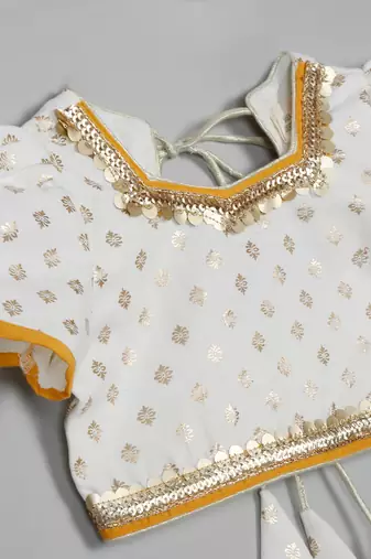 Saka designs girls foil printed lacework white choli with mustard lehenga choli
