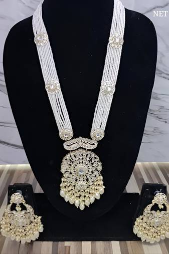 Elegant multi-layered pearl necklace set with intricate silver pendant and earrings