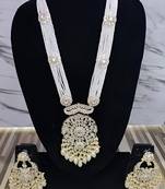 Elegant multi-layered pearl necklace set with intricate silver pendant and earrings