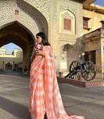 Grace and tradition meet in the exquisite Kota Doria Peach Saree.