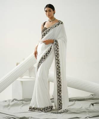 White floral border saree paired with black geometric cutdana blouse 1