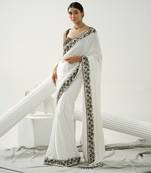 White floral border saree paired with black geometric cutdana blouse