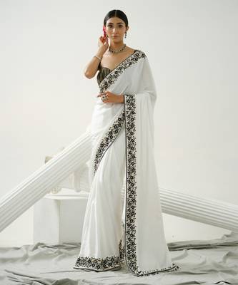 White floral border saree paired with black geometric cutdana blouse 2