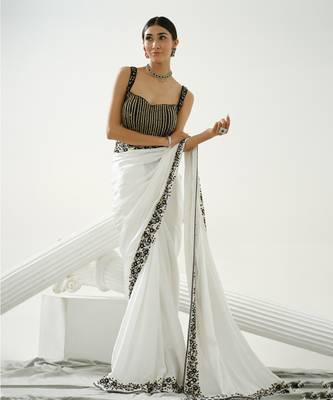White floral border saree paired with black geometric cutdana blouse 3