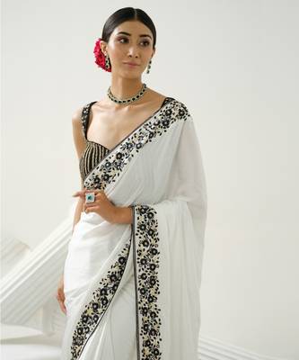 White floral border saree paired with black geometric cutdana blouse 4