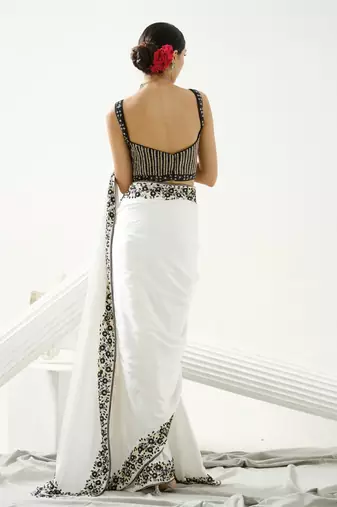 White floral border saree paired with black geometric cutdana blouse