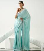 Ocean green sequin saree with border work paired with shaded sequin pink blouse