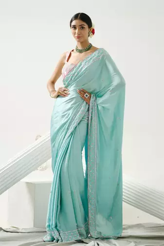 Ocean green sequin saree with border work paired with shaded sequin pink blouse