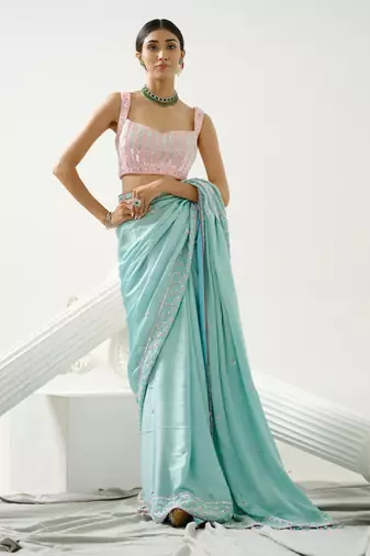 Ocean green sequin saree with border work paired with shaded sequin pink blouse