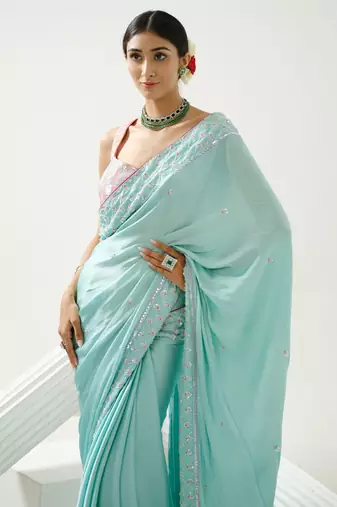 Ocean green sequin saree with border work paired with shaded sequin pink blouse