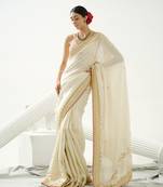 Gold silk tissue saree handrafted with sequin , cutdana paired with gold sequin embellished strap crossback blouse