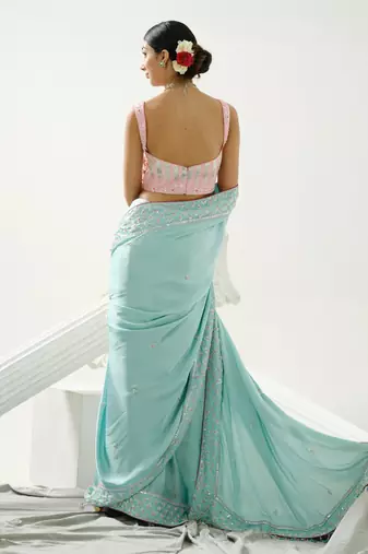 Ocean green sequin saree with border work paired with shaded sequin pink blouse