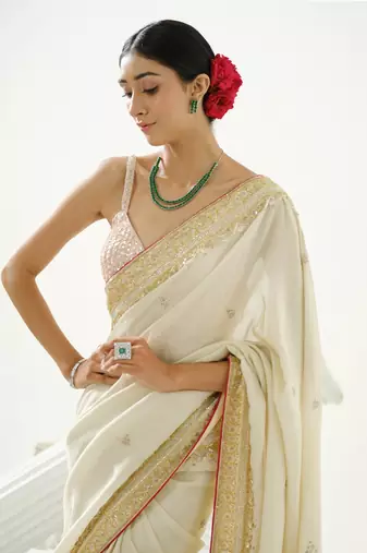 Gold silk tissue saree handrafted with sequin , cutdana paired with gold sequin embellished strap crossback blouse