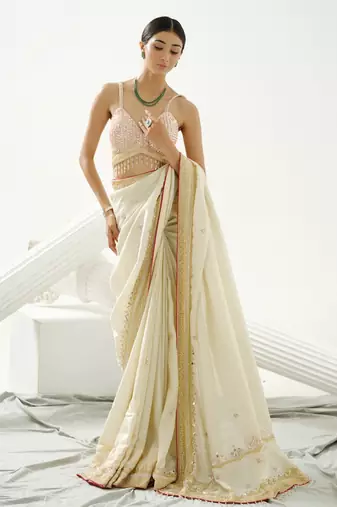 Gold silk tissue saree handrafted with sequin , cutdana paired with gold sequin embellished strap crossback blouse