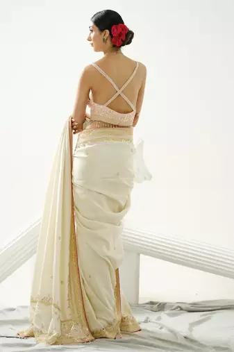 Gold silk tissue saree handrafted with sequin , cutdana paired with gold sequin embellished strap crossback blouse