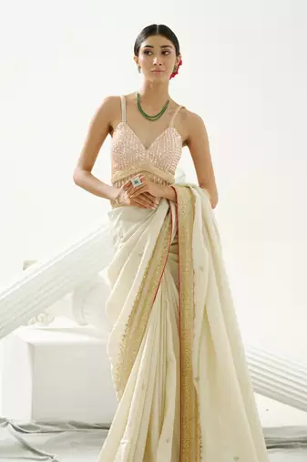 Gold silk tissue saree handrafted with sequin , cutdana paired with gold sequin embellished strap crossback blouse