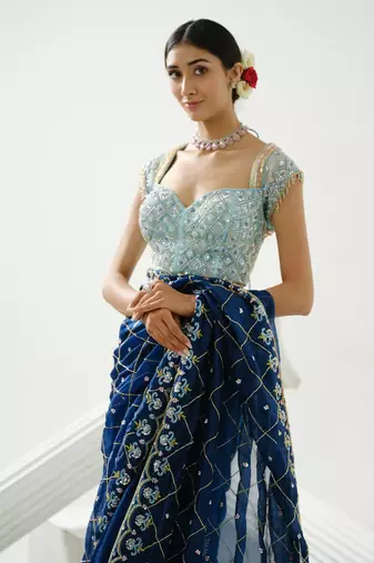 Blue organza floral handcrafted saree paired with sea blue geometric sequin blouse