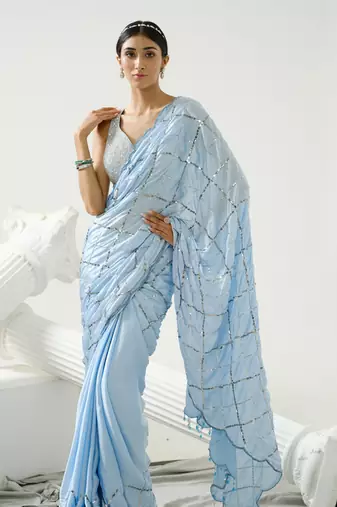 Powder blue sequin scallop saree paired with steel grey sequin strap blouse