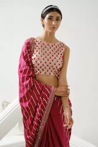 Cherry pink linear handcrafted saree paired with satin incut handcrafted blouse