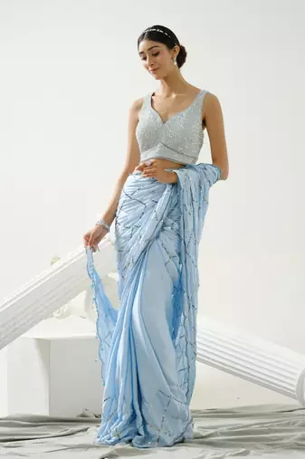Powder blue sequin scallop saree paired with steel grey sequin strap blouse