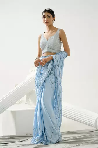 Powder blue sequin scallop saree paired with steel grey sequin strap blouse
