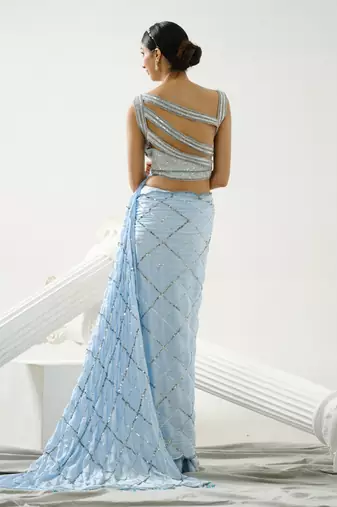 Powder blue sequin scallop saree paired with steel grey sequin strap blouse