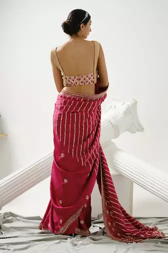 Cherry pink linear handcrafted saree paired with satin incut handcrafted blouse