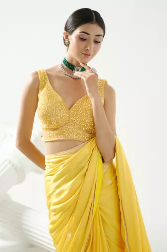 Yellow crystal and sequin handcrafted saree paired with sequin strap blouse