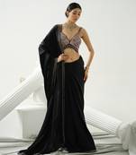 Black geometric satin silk saree paired with a sequin embellished  cross back strap blouse