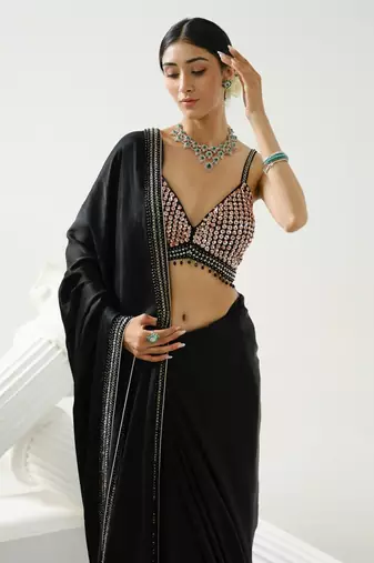 Black geometric satin silk saree paired with a sequin embellished  cross back strap blouse