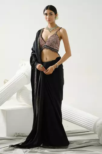 Black geometric satin silk saree paired with a sequin embellished  cross back strap blouse