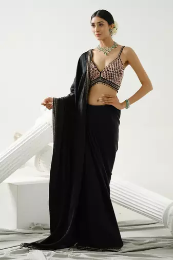 Black geometric satin silk saree paired with a sequin embellished  cross back strap blouse