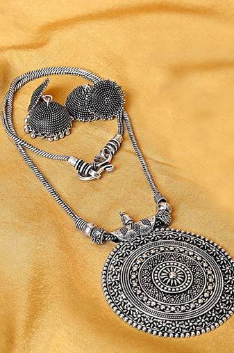 Oxidised silver-plated jewelry set with circular textured centerpiece and jhumkas