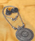 Oxidised silver-plated jewelry set with circular textured centerpiece and jhumkas
