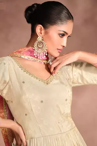 cream embroidered jacquard free size stitched gown.(size up to 42")